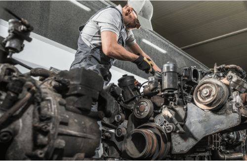 Mobile mechanic working on a semi truck engine